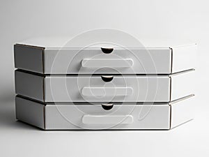 Stack of three closed pizza boxes on a clean surface