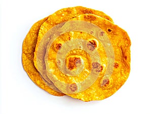 A stack of three flatbreads on a white surface