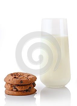 Stack of three homemade chocolate chip cookies and glass of milk