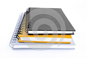 Stack of three notebooks or copybooks on white background