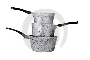 Stack of three saucepans isolated