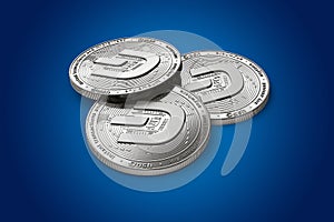 Stack of three silver Dash coins with 2019 logo update, isolated on blue background. 3D rendering