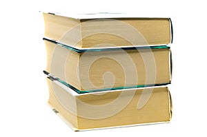 Stack of three thick books on white background. Paper dictionaries, encyclopedias and reference books