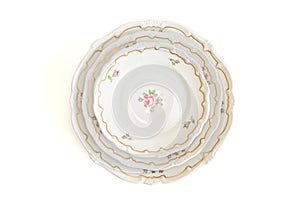 Stack of three white plates and saucers top view