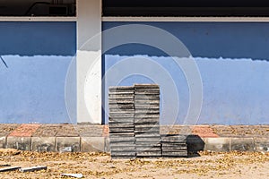 A stack of tiles piled outside an old traditional house