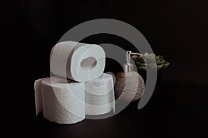 Stack of toilet paper rolls on black background