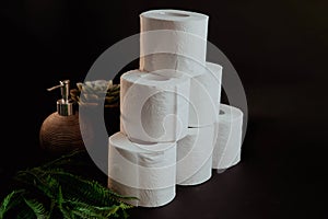 Stack of toilet paper rolls on black background