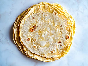 A stack of tortillas sitting on top of a white table