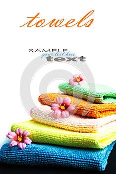 Stack of towels and flowers.