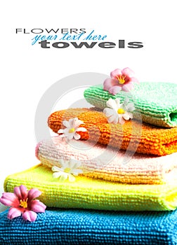 Stack of towels and flowers.