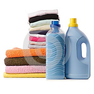 A stack of towels and launder a bottle of liquid powder conditioner softener