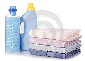 A stack of towels softener conditioner liquid laundry detergent