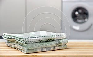 A stack of towels on a wooden table photo