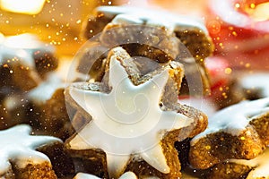 Stack of Traditional German Christmas Cookies Home Baked Glazed Cinnamon Stars Sparkling Garland Lights Candle Candy Canes Festive