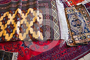 stack of traditional oriental Arab Uzbek handmade colorful carpets at bazaar in Uzbekistan in Tashkent