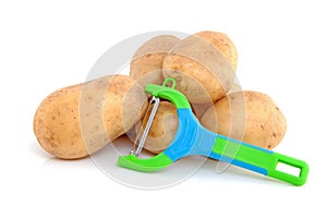 Stack of unpeeled potatoes and peeling knife