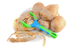 Stack of unpeeled potatoes and peeling knife