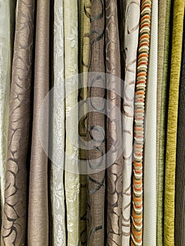 Stack of upholstery fabric swatch for luxury furniture with many color and pattern.