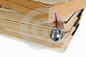 Stack of used books with a hand-made bookmark