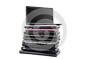 Stack of used laptops in different colors and models. T photo