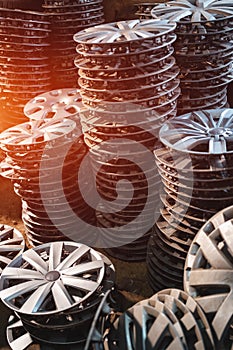 stack of various alloy wheels in tire store