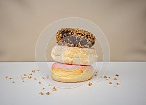 Stack for various delicious donuts isolated on white background.