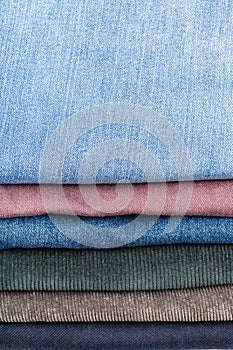 Stack of various jeans close up