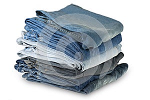 various shades of blue jeans trousers at white background