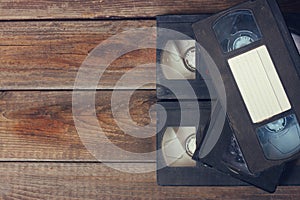 Stack of VHS video tape cassette over wooden background. top view photo