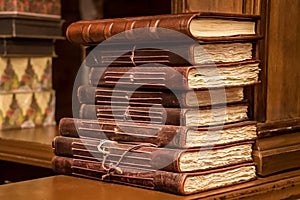 Stack of vintage leather-bound journals with aged pages