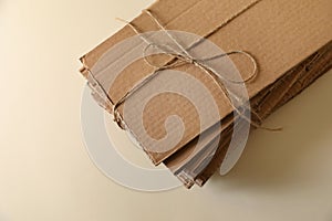 Stack of waste paper on beige background, closeup