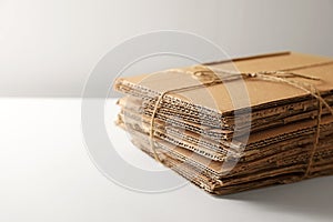 Stack of waste paper on beige background, closeup. Space or text