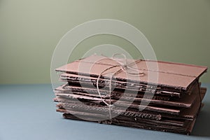 Stack of waste paper on grey table, space for text