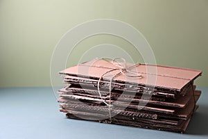 Stack of waste paper on grey table, space for text