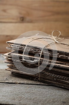 Stack of waste paper on wooden table, closeup