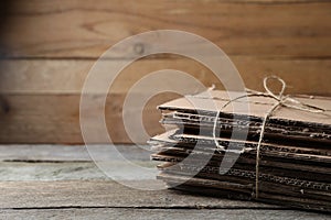 Stack of waste paper on wooden table, closeup. Space for text