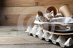 Stack of waste paper on wooden table, closeup. Space for text