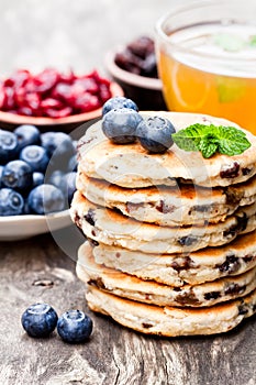 Stack of welsh cakes with blueberry and a cup of green tea