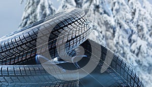 Stack of wheel new black tyres for winter car driving isolated on colored background