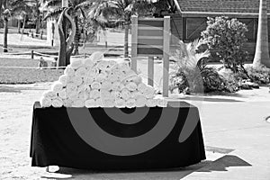 Stack of white, bath towels rolled up on black table
