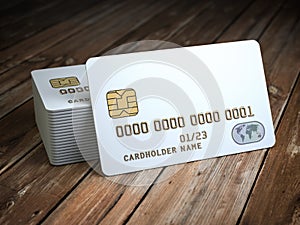 Stack of white blank credit cards mockup on wooden table background