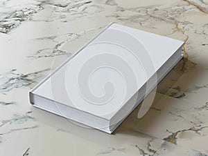 A stack of white books sitting on top of a marble table
