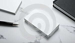 Stack of White Business Cards with Black Notebook and Pen on Marble Background