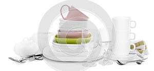 Stack of white ceramic kitchenware and cutlery, isolated on white background