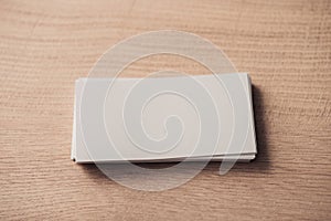 stack of white empty business cards on wooden surface.