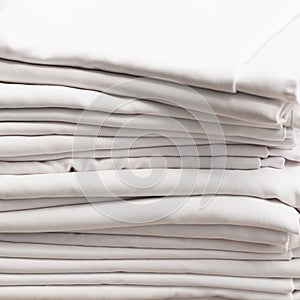 Stack of white folded cotton tablecloths
