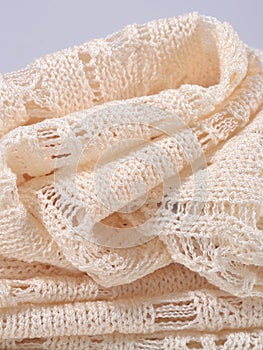 Stack of white openwork knitted fabric