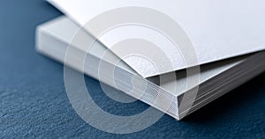 A stack of white paper on a blue background