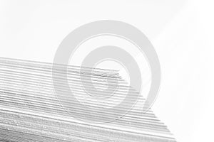 Stack of white paper. Blurring background. The corners of sheets of paper close-up.