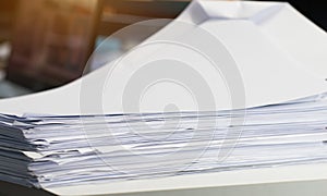 Stack white paper Document pile on office desk, Stack of business paper on table with blurred of meeting room background. Job busy
